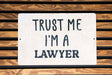 a white sign that says trust me i'm a lawyer
