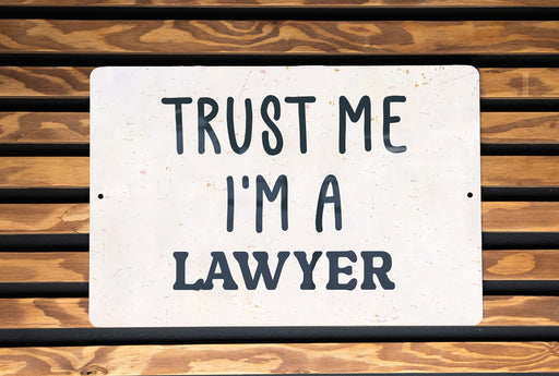 a white sign that says trust me i'm a lawyer