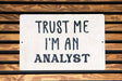 a sign that says trust me i'm an analyst