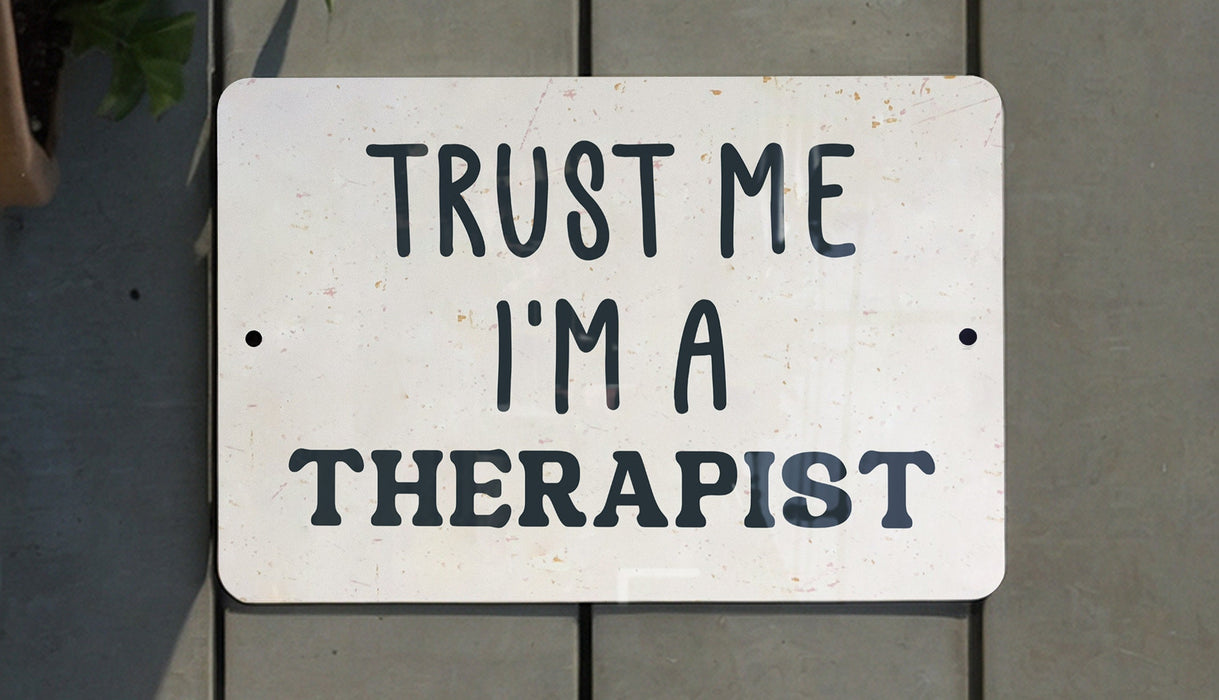 a white sign that says trust me i'm a therapist