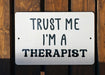 a sign that says trust me i'm a therapist