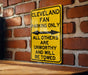 a yellow sign on a brick wall that says cleveland fan parking only all others are
