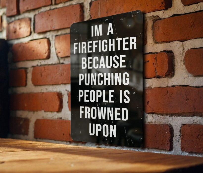 a sign on a brick wall that says i'm a firefighter because punching