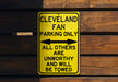 a yellow parking only sign on a wooden wall