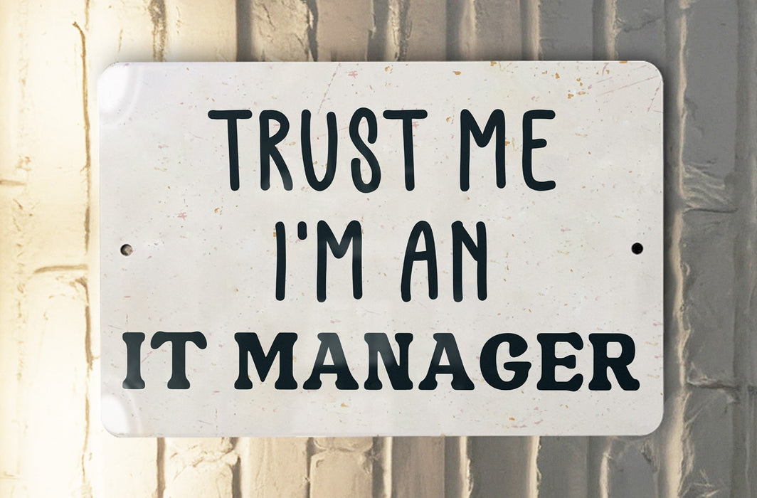 a white sign that says trust me i'm an it manager