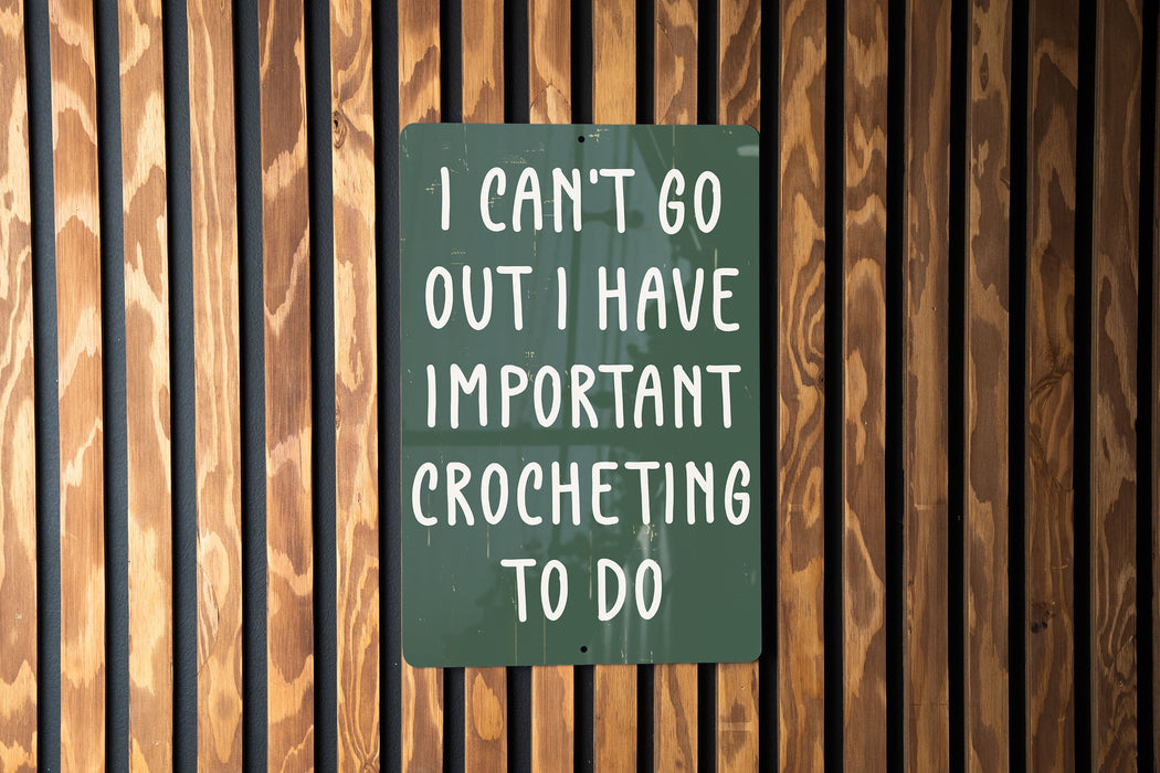 a green sign that says i can't go out i have important croche