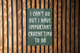 a green sign that says i can't go out i have important croche