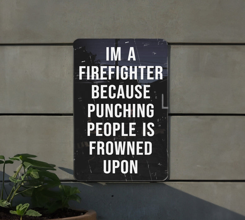 a sign on a wall that says i'm a firefighter because punching people