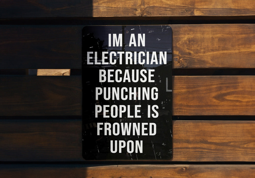 a sign on a wooden bench that says i'm an electrician because punching