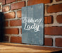 a sign that reads baking lady on a brick wall