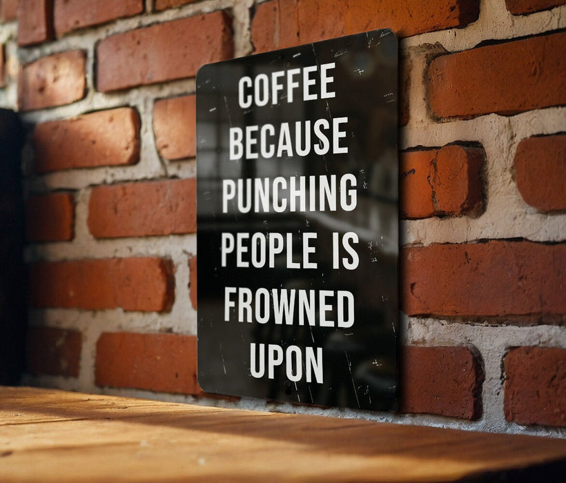 a sign on a brick wall that says coffee because punching people is frowned upon