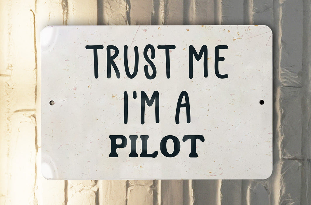 a white sign that says trust me i'm a pilot
