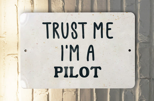 a white sign that says trust me i'm a pilot