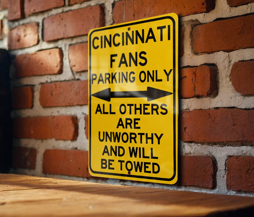 a yellow street sign on a brick wall