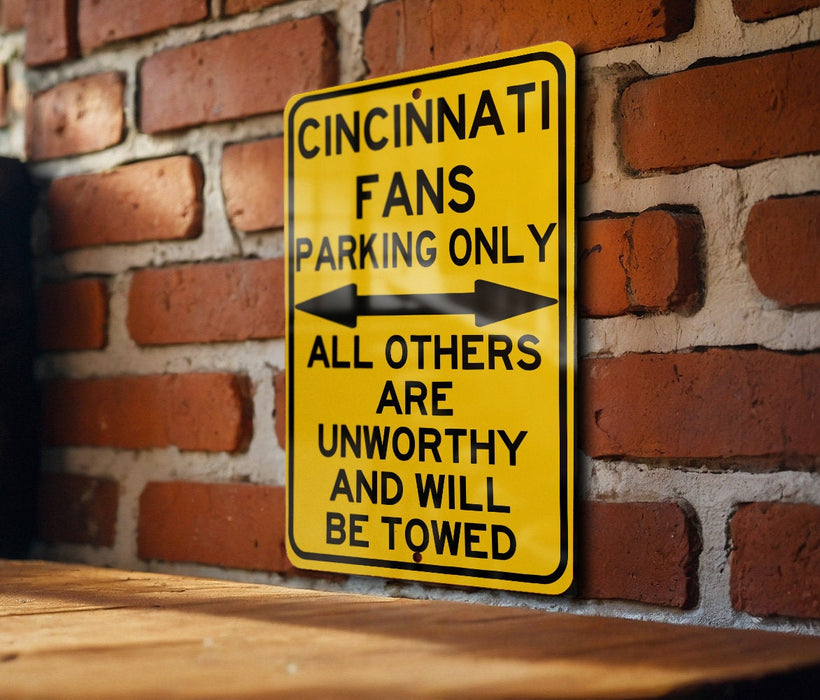 a yellow street sign on a brick wall
