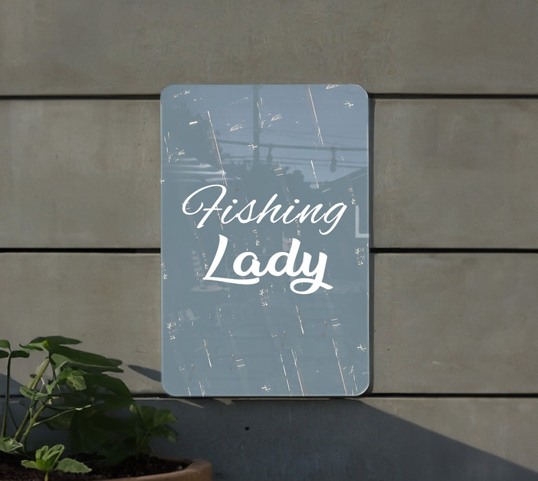 a sign that says fishing lady next to a potted plant