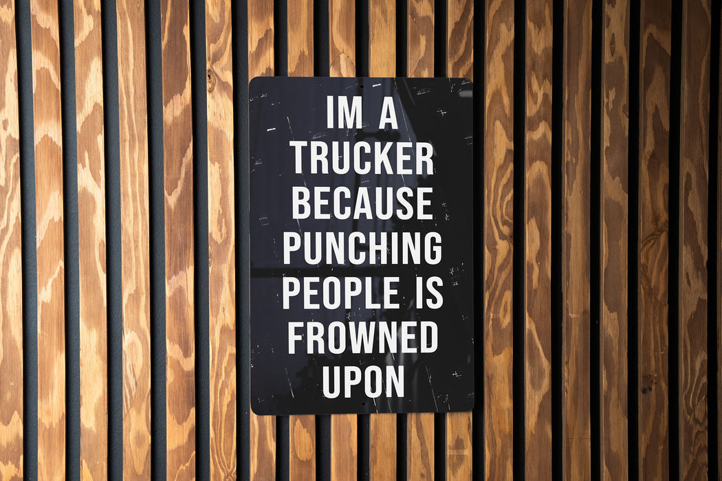 a sign on a wooden wall that says i'm a trucker because punching