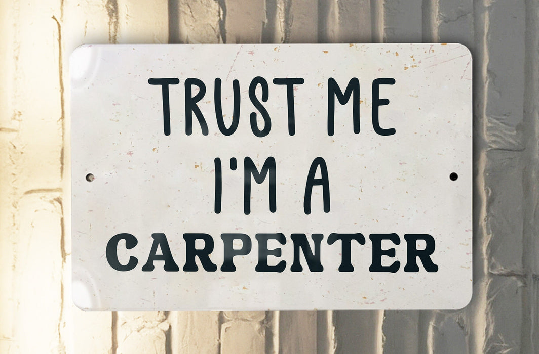 a white sign that says trust me i'm a carpenter