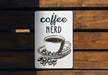 a sign that says coffee nerd on it