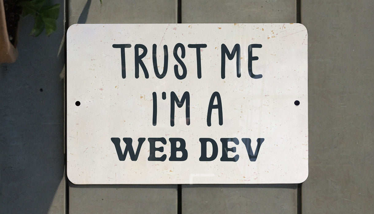 a white sign that says trust me i'm a web dev