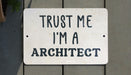 a white sign that says trust me i'm a architecture