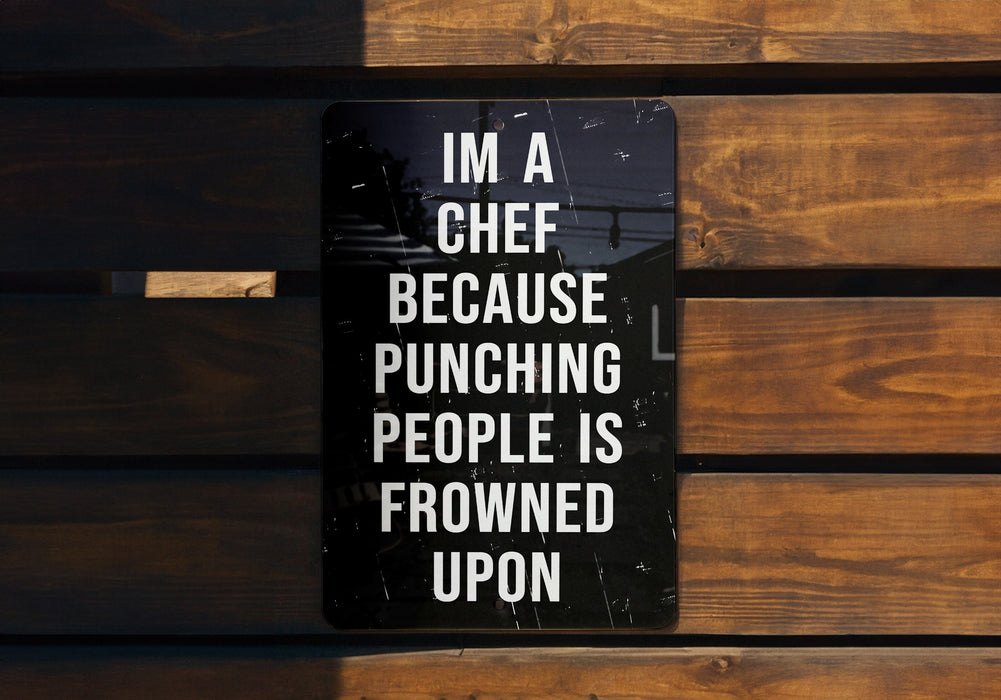 a sign on a wooden bench that says i'm a chef because punching people