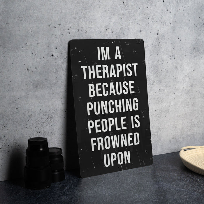 a sign that says i'm a therapist because punching people is