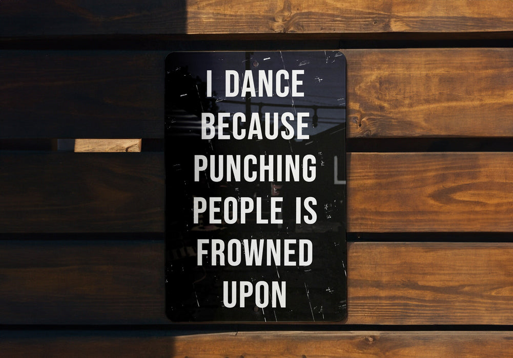 a sign on a wooden bench that says i dance because punching people is frowned