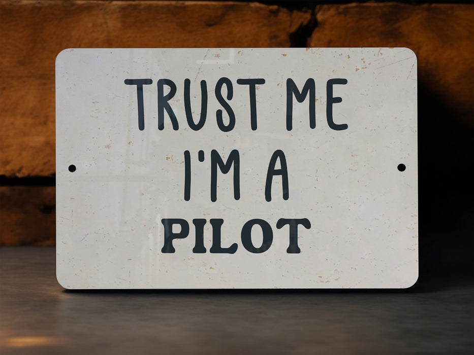 a white sign that says trust me i'm a pilot