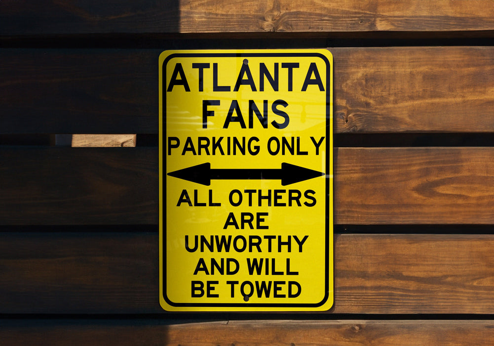 a yellow street sign on a wooden wall