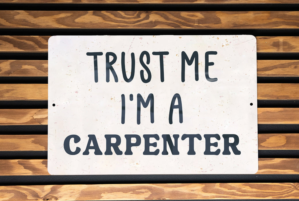 a white sign that says trust me i'm a carpenter