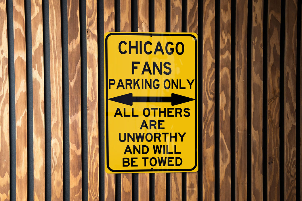 a chicago fans parking only sign on a wooden wall