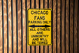 a chicago fans parking only sign on a wooden wall