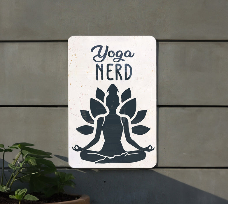 a sign that says yoga nerd next to a potted plant