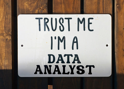 a white sign that says trust me i'm a data analist