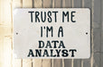 a white sign that says trust me i'm a data analist