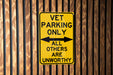 a yellow sign that says vet parking only all others are unworthyly