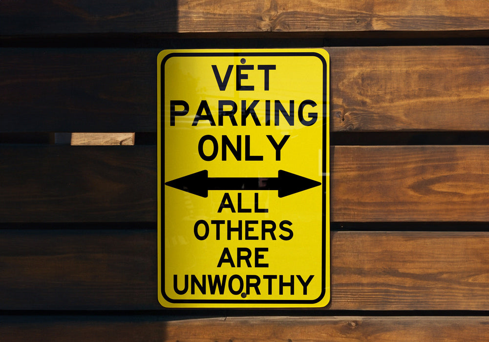 a yellow sign that says vet parking only all others are unworthyly