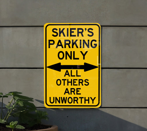 a yellow sign that says skier's parking only all others are unworthyly