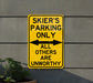 a yellow sign that says skier's parking only all others are unworthyly