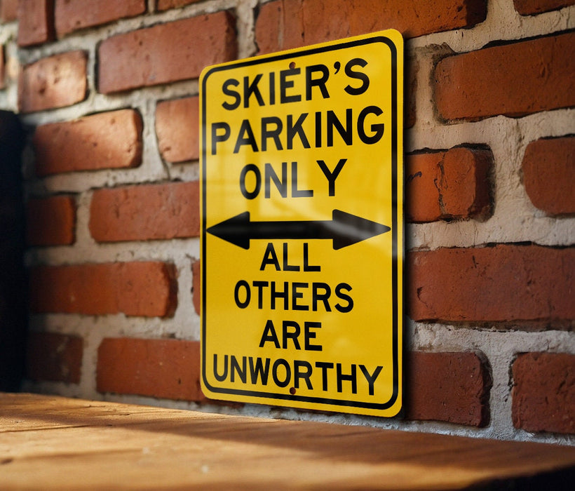 a yellow parking only sign on a brick wall