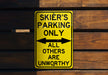 a yellow parking only sign hanging on a wooden wall