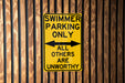 a yellow and black sign on a wooden wall