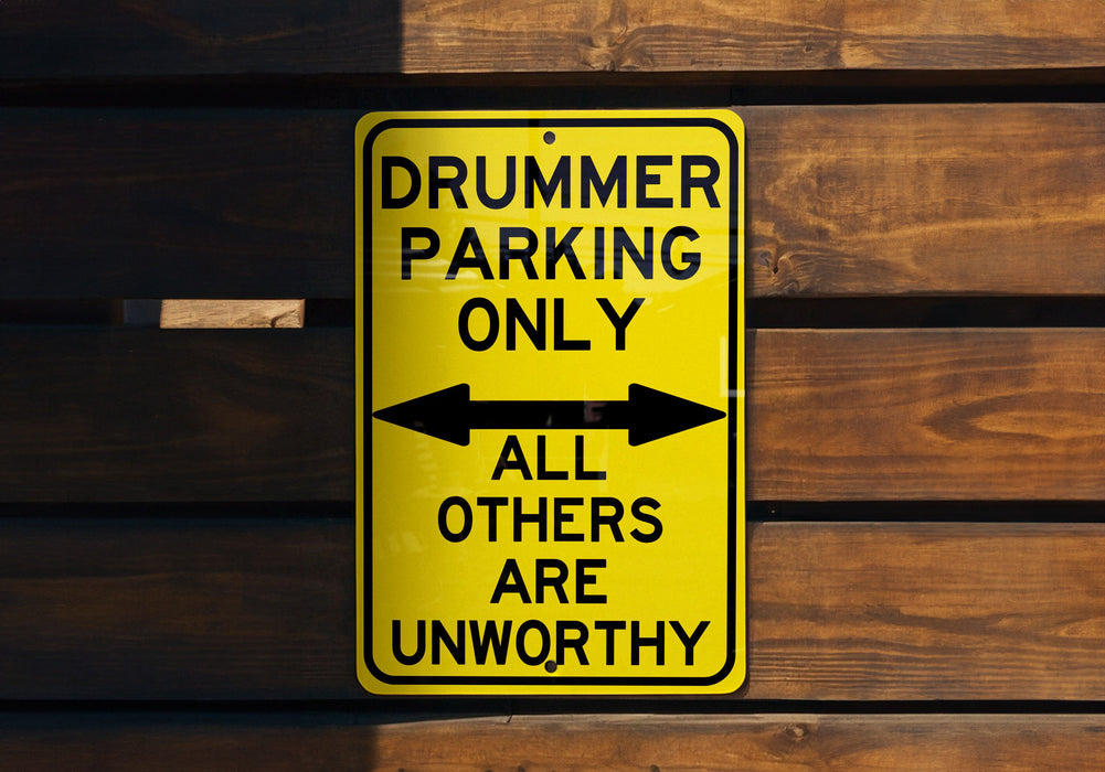 a yellow sign that says drummer parking only all others are unworthyly