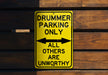 a yellow sign that says drummer parking only all others are unworthyly