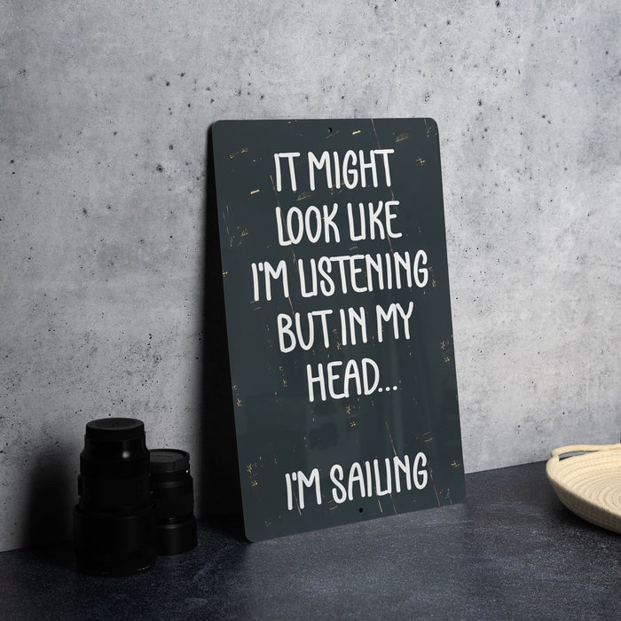 a sign that says it might look like i'm listening but in my head