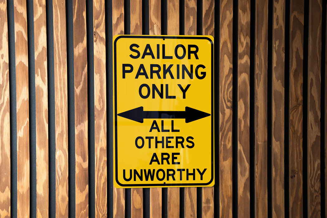 a yellow and black sign on a wooden wall
