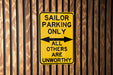 a yellow and black sign on a wooden wall