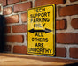 a yellow sign on a brick wall that says tech support parking only all others are