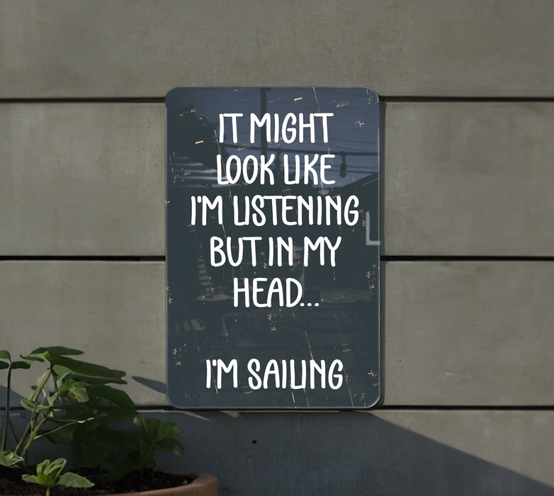 a sign that says it might look like i'm listening but in my head